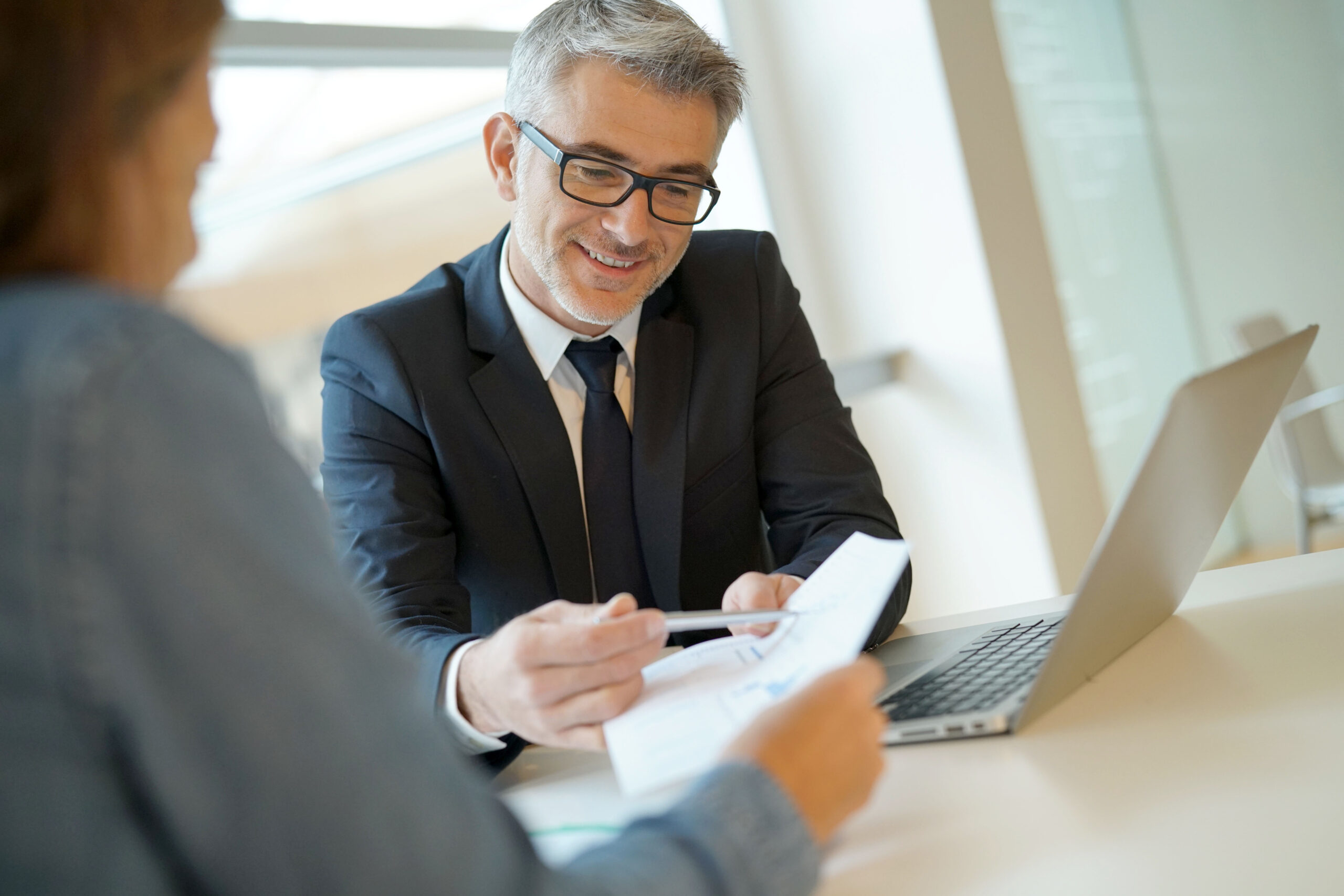 Woman,In,Banker's,Office,Signing,Financial,Loan,For,Project